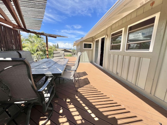 wooden terrace featuring outdoor dining area