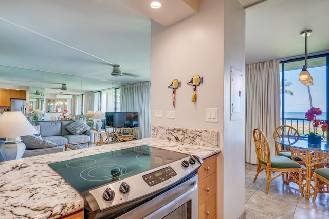 kitchen featuring a healthy amount of sunlight, stainless steel appliances, pendant lighting, and ceiling fan