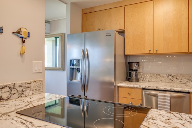 kitchen featuring tasteful backsplash, stainless steel appliances, light brown cabinets, and light stone counters