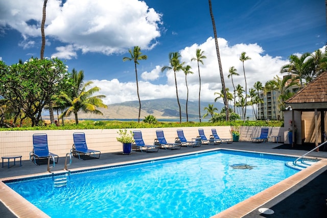 view of pool with a mountain view and a patio area