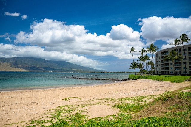 water view with a beach view and a mountain view