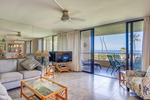 tiled living room featuring a water view, a wealth of natural light, ceiling fan, and a wall of windows