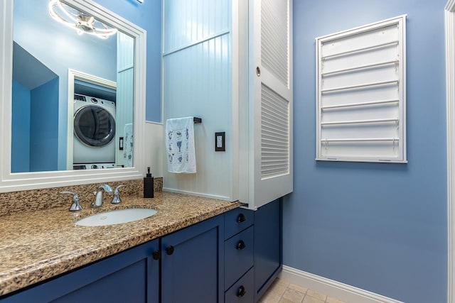 bathroom with vanity and stacked washer / drying machine