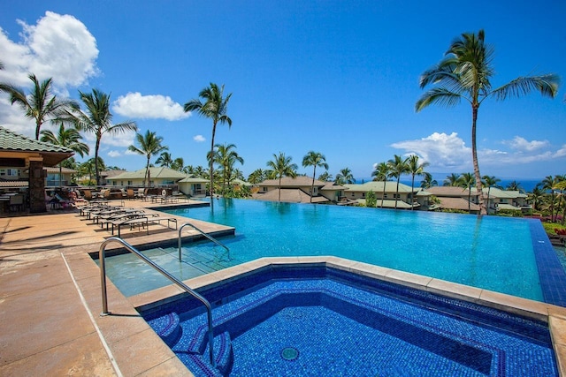 view of pool with a hot tub