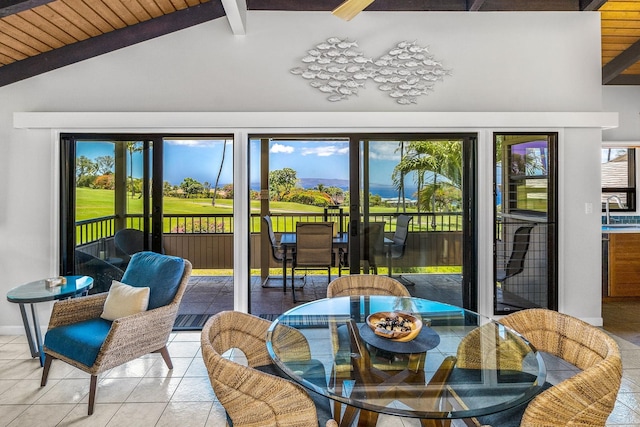 sunroom featuring vaulted ceiling with beams, a wealth of natural light, and wooden ceiling