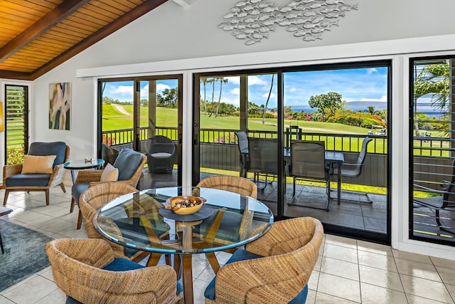 sunroom / solarium with lofted ceiling with beams, wood ceiling, and a wealth of natural light