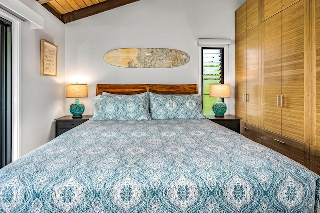 bedroom featuring a closet, wooden ceiling, and lofted ceiling