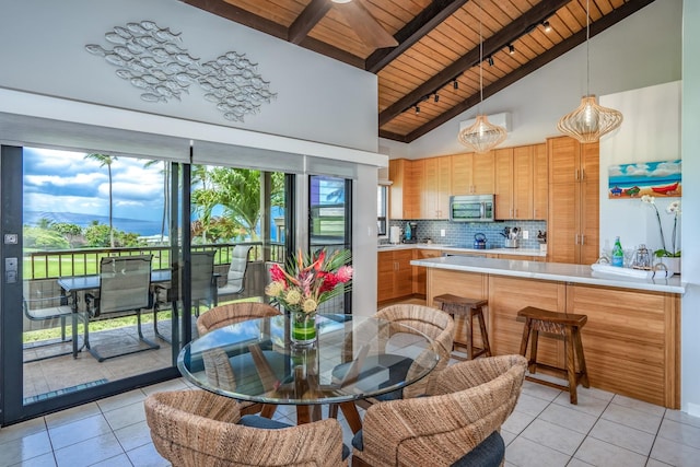 tiled dining space featuring beam ceiling, wood ceiling, and high vaulted ceiling