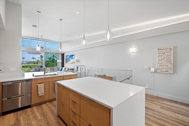 209 Holokahiki Ln Unit 103, Kihei, HI 96753 - kitchen with light wood-type flooring, modern cabinets, dishwasher, and a sink