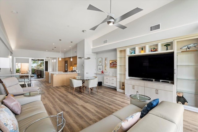 209 Holokahiki Ln Unit 103, Kihei, HI 96753 - living room featuring light wood finished floors, a ceiling fan, visible vents, and high vaulted ceiling