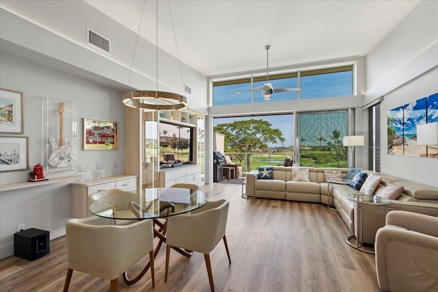 209 Holokahiki Ln Unit 103, Kihei, HI 96753 - dining space featuring a towering ceiling, visible vents, and wood finished floors