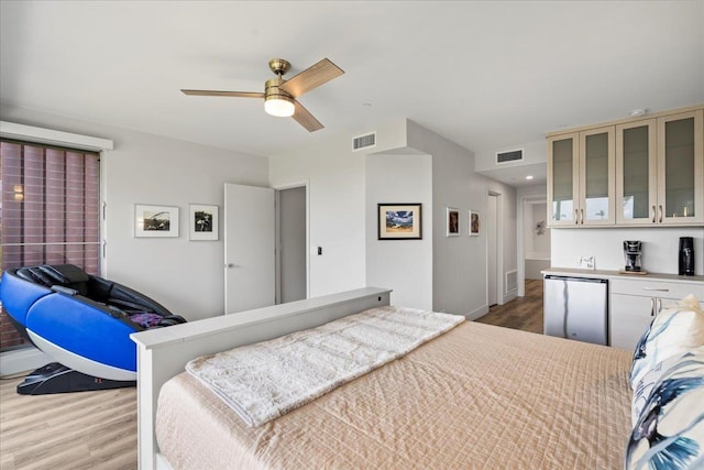 209 Holokahiki Ln Unit 103, Kihei, HI 96753 - bedroom with wood finished floors, visible vents, refrigerator, and baseboards
