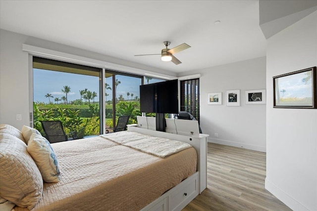 209 Holokahiki Ln Unit 103, Kihei, HI 96753 - bedroom featuring access to exterior, ceiling fan, wood finished floors, and baseboards