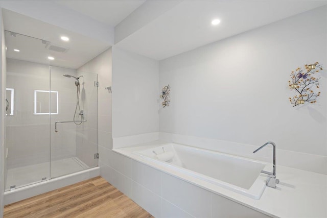 209 Holokahiki Ln Unit 103, Kihei, HI 96753 - bathroom with visible vents, a garden tub, a stall shower, recessed lighting, and wood finished floors