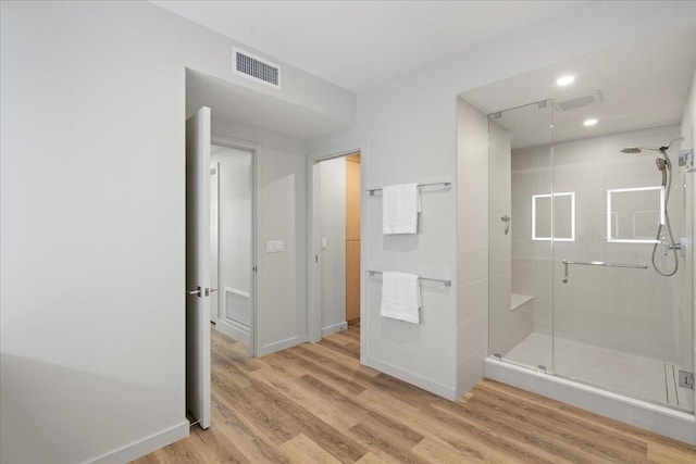 209 Holokahiki Ln Unit 103, Kihei, HI 96753 - full bathroom featuring baseboards, visible vents, wood finished floors, and a shower stall