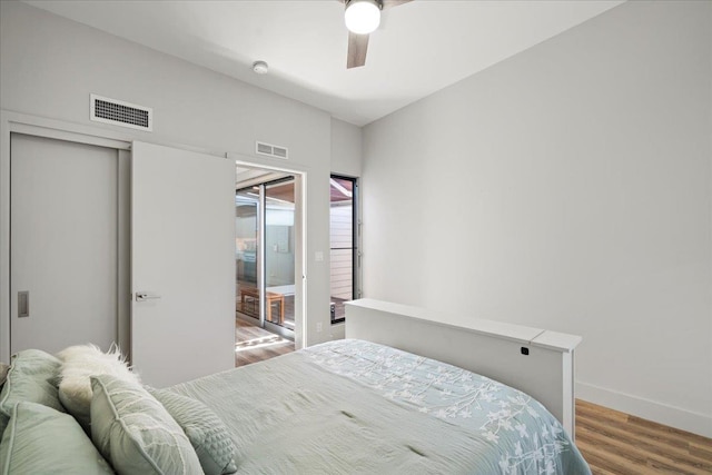 209 Holokahiki Ln Unit 103, Kihei, HI 96753 - bedroom with a ceiling fan, visible vents, wood finished floors, and baseboards
