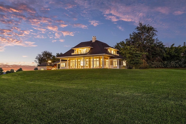 back house at dusk with a yard