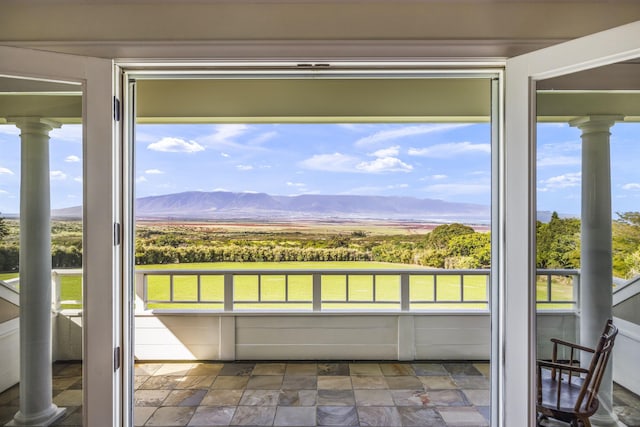 unfurnished sunroom with a mountain view and plenty of natural light