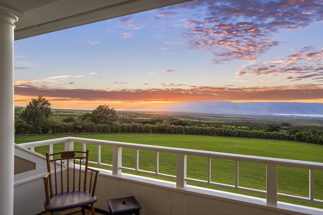 view of balcony at dusk