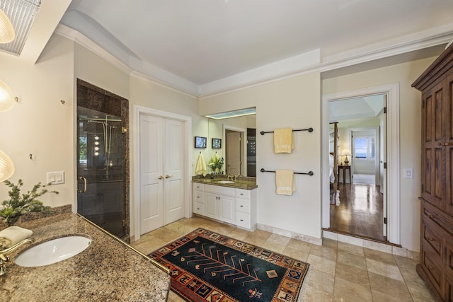 bathroom with vanity, an enclosed shower, and hardwood / wood-style flooring