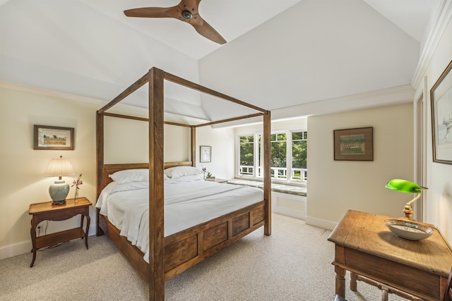 carpeted bedroom with vaulted ceiling, ceiling fan, and crown molding