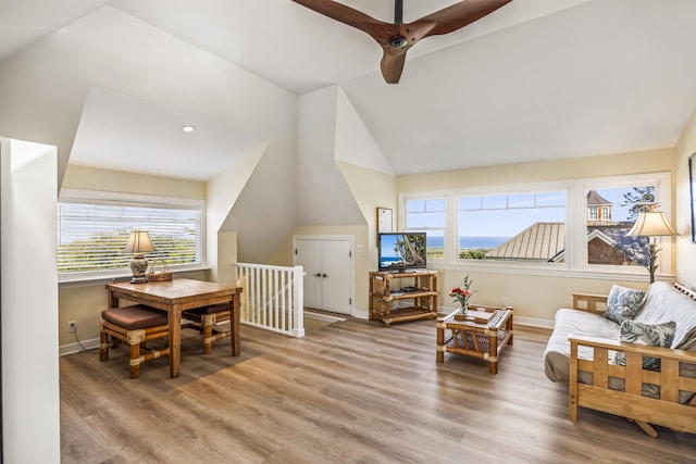 interior space featuring wood-type flooring, a wealth of natural light, lofted ceiling, and ceiling fan