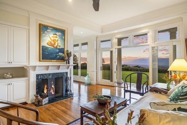 sunroom / solarium featuring ceiling fan and a fireplace