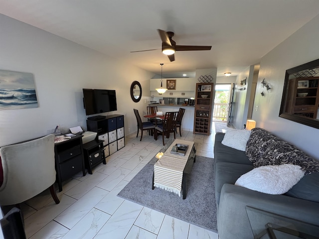 living room with ceiling fan and vaulted ceiling