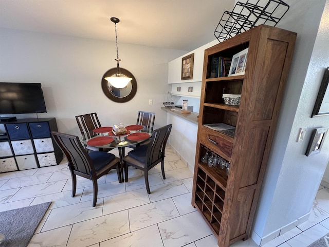 dining space featuring vaulted ceiling