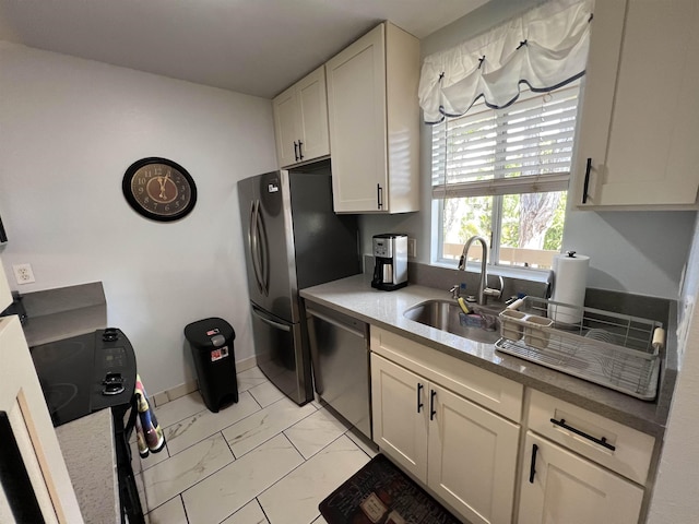 kitchen featuring white cabinetry, sink, and stainless steel appliances