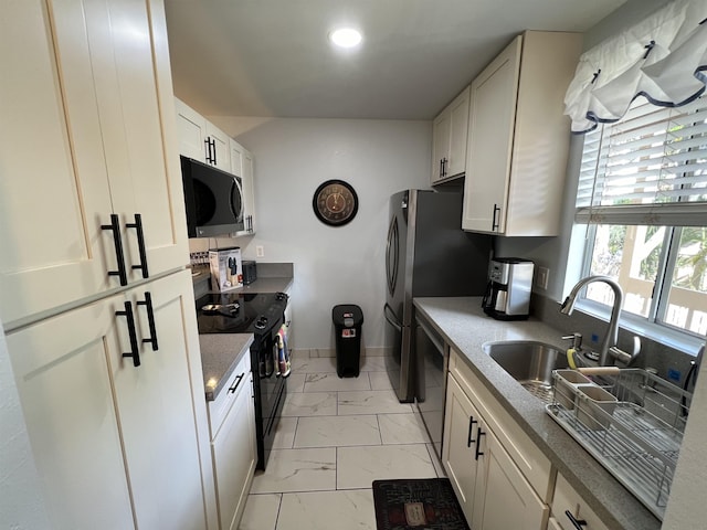 kitchen with white cabinetry and appliances with stainless steel finishes