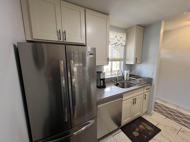 kitchen with white cabinetry, sink, and appliances with stainless steel finishes