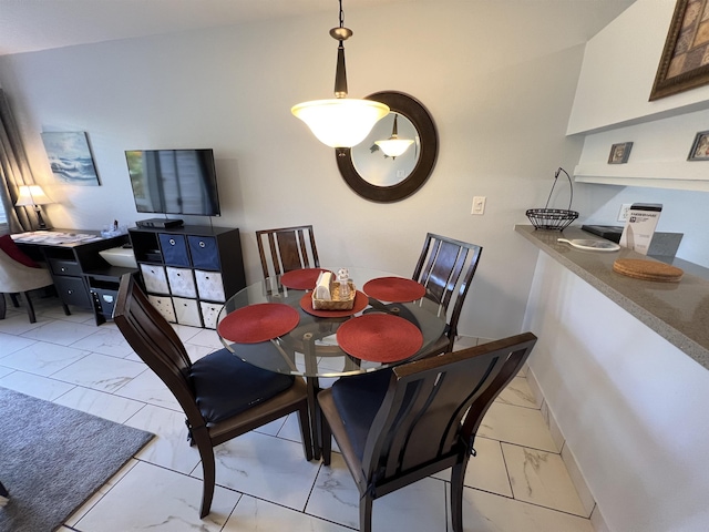 dining room with vaulted ceiling