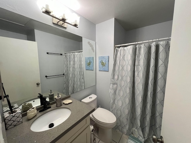 bathroom with a shower with curtain, tile patterned flooring, vanity, and toilet