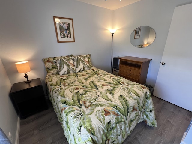 bedroom with dark wood-type flooring