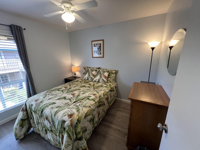 bedroom with dark hardwood / wood-style flooring and ceiling fan