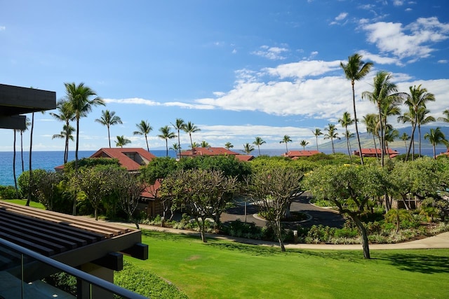 surrounding community featuring a water view and a yard