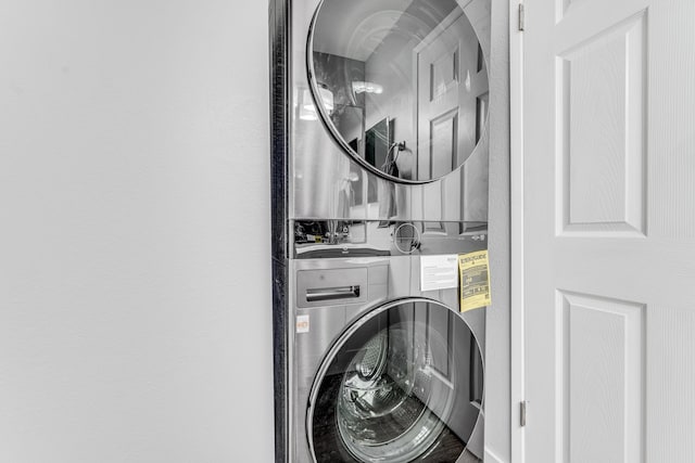 clothes washing area featuring stacked washer / drying machine