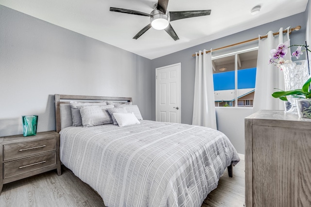 bedroom featuring ceiling fan and light hardwood / wood-style flooring