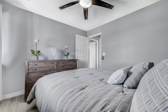 bedroom with ceiling fan and light wood-type flooring