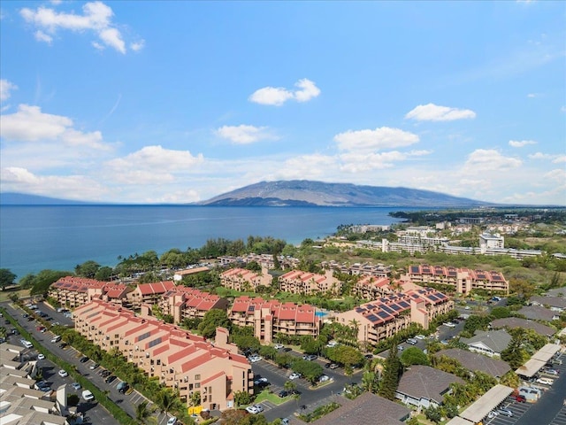 drone / aerial view featuring a water and mountain view