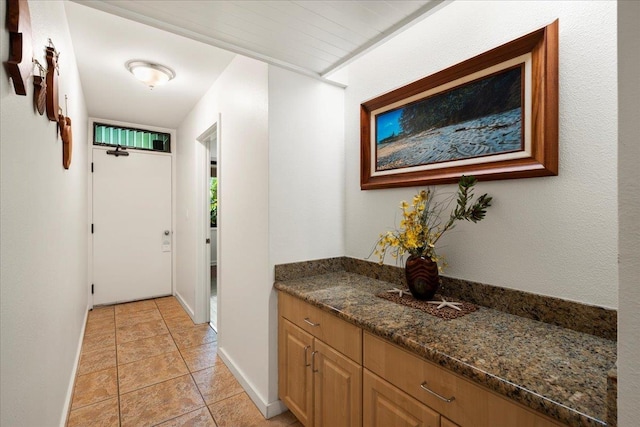 hall featuring light tile patterned floors