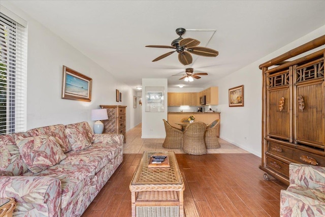 living room featuring light wood-type flooring and a ceiling fan