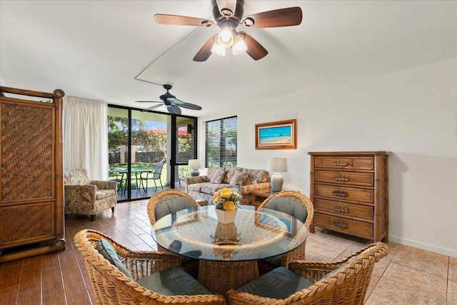 dining space with floor to ceiling windows, baseboards, and a ceiling fan