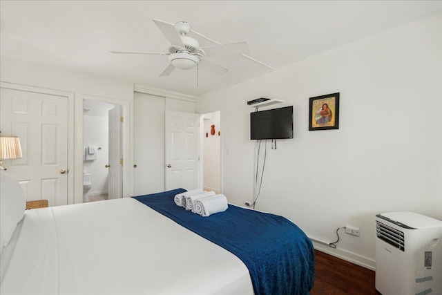 bedroom featuring connected bathroom, wood finished floors, a ceiling fan, a closet, and baseboards