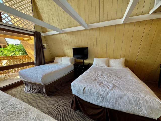 carpeted bedroom featuring wooden walls and lofted ceiling with beams