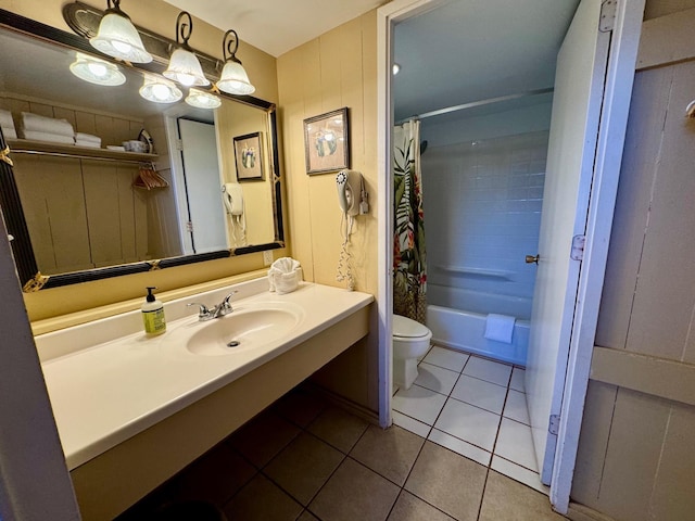 full bathroom with sink, toilet, tile patterned floors, and shower / bath combo with shower curtain