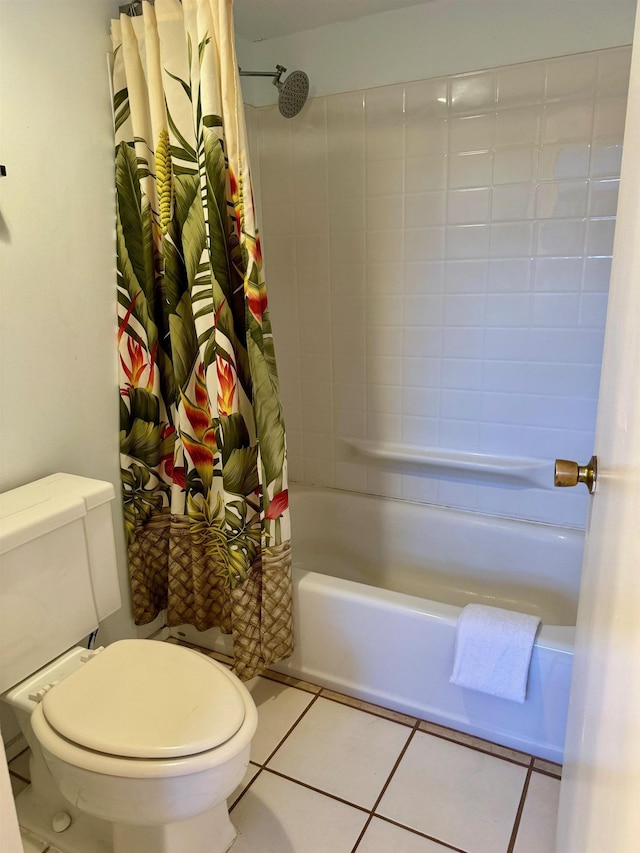 bathroom featuring toilet, tile patterned floors, and shower / tub combo with curtain