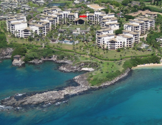 birds eye view of property with a view of the beach and a water view