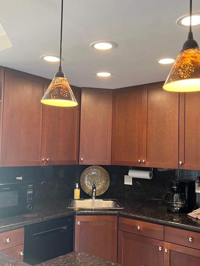 kitchen with backsplash, dark stone countertops, and pendant lighting